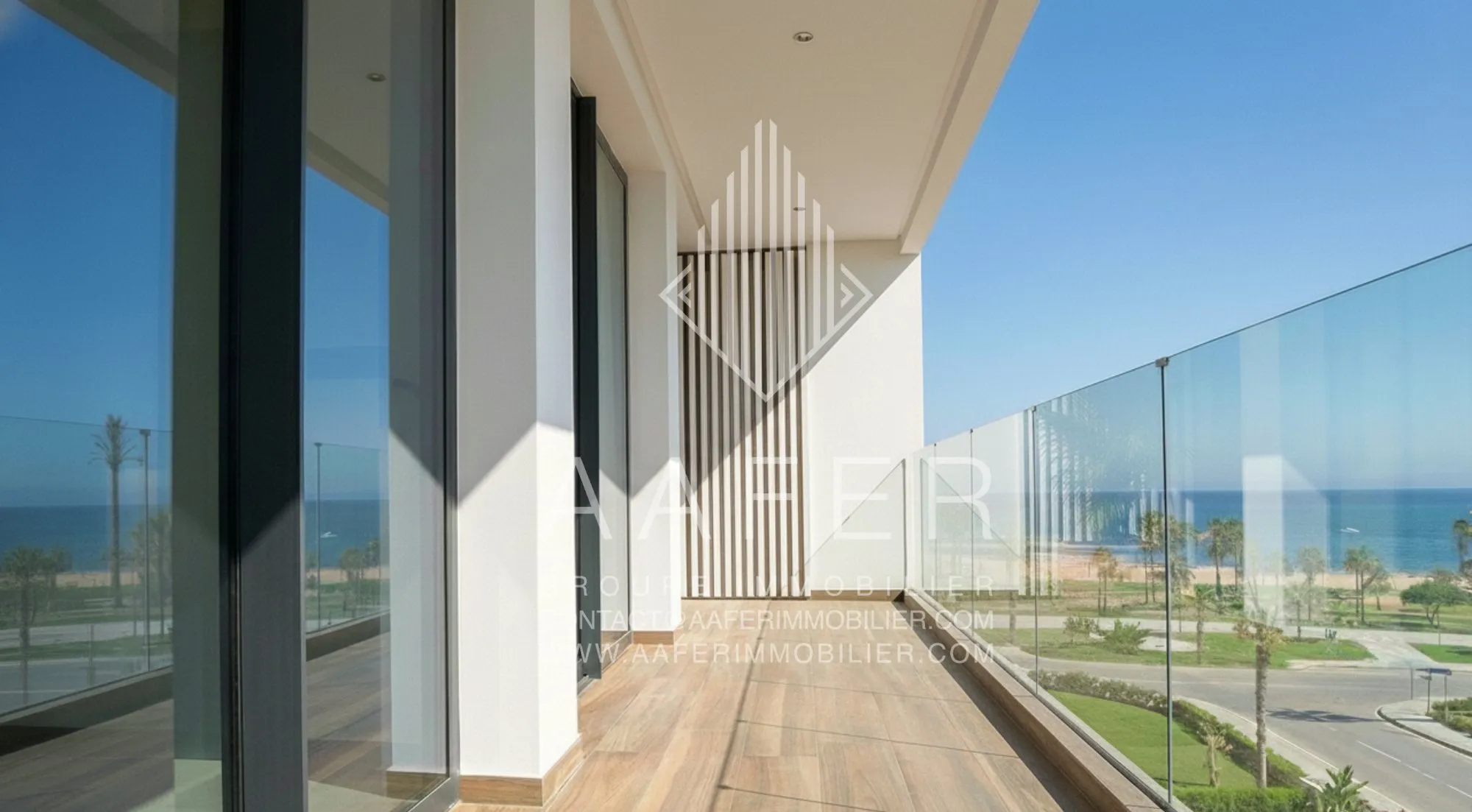 Balkon met glazen balustrade en zicht op de baai van Tanger